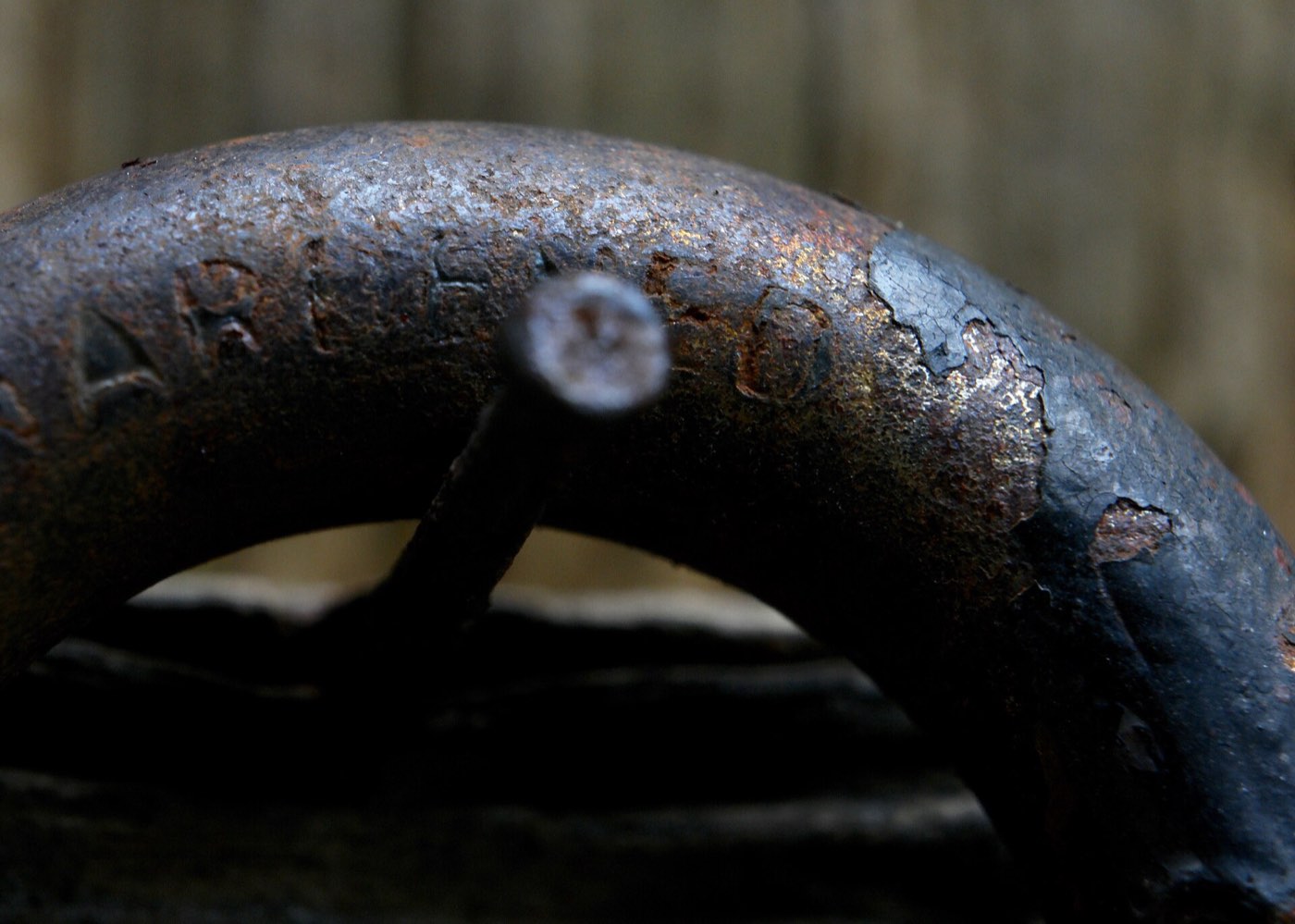 Close-up of the shackle of a rusted padlock